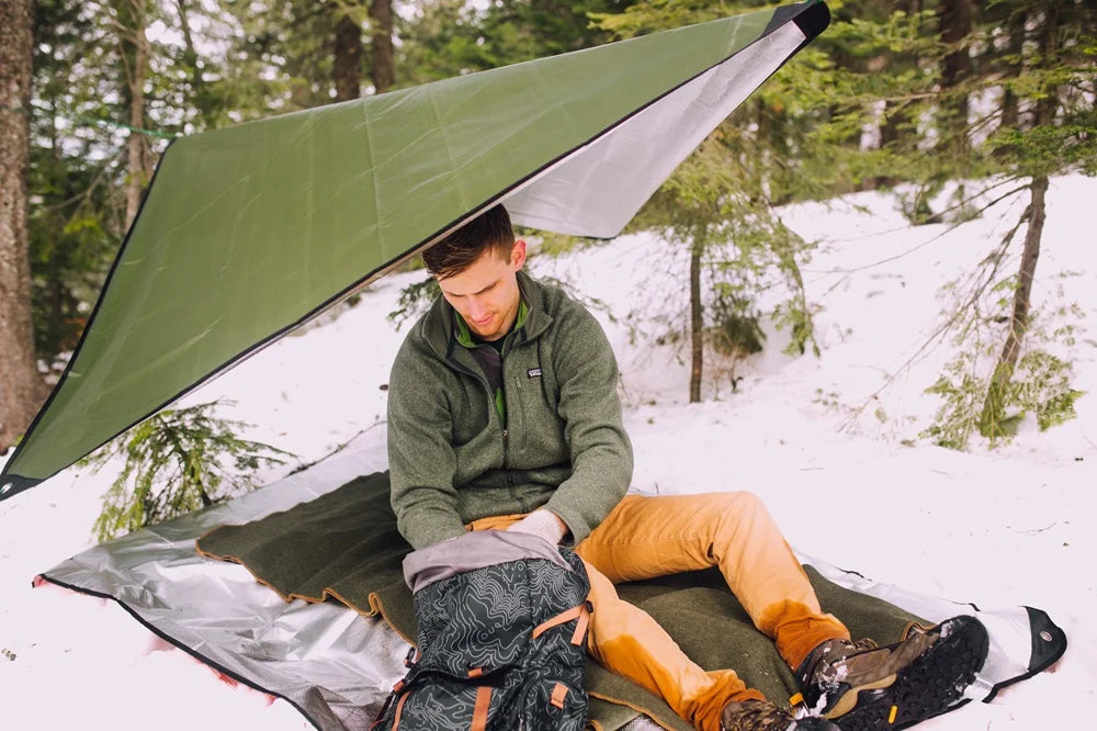 Arcturus survival blanket used as emergency shelter for cold weather camping or bushcraft survival